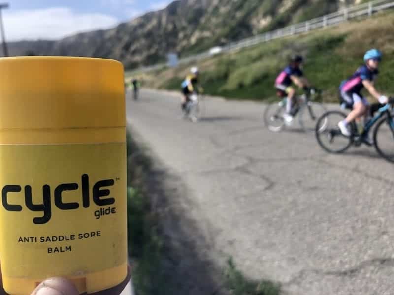 hand holding stick of cycle glide anti saddle sore balm